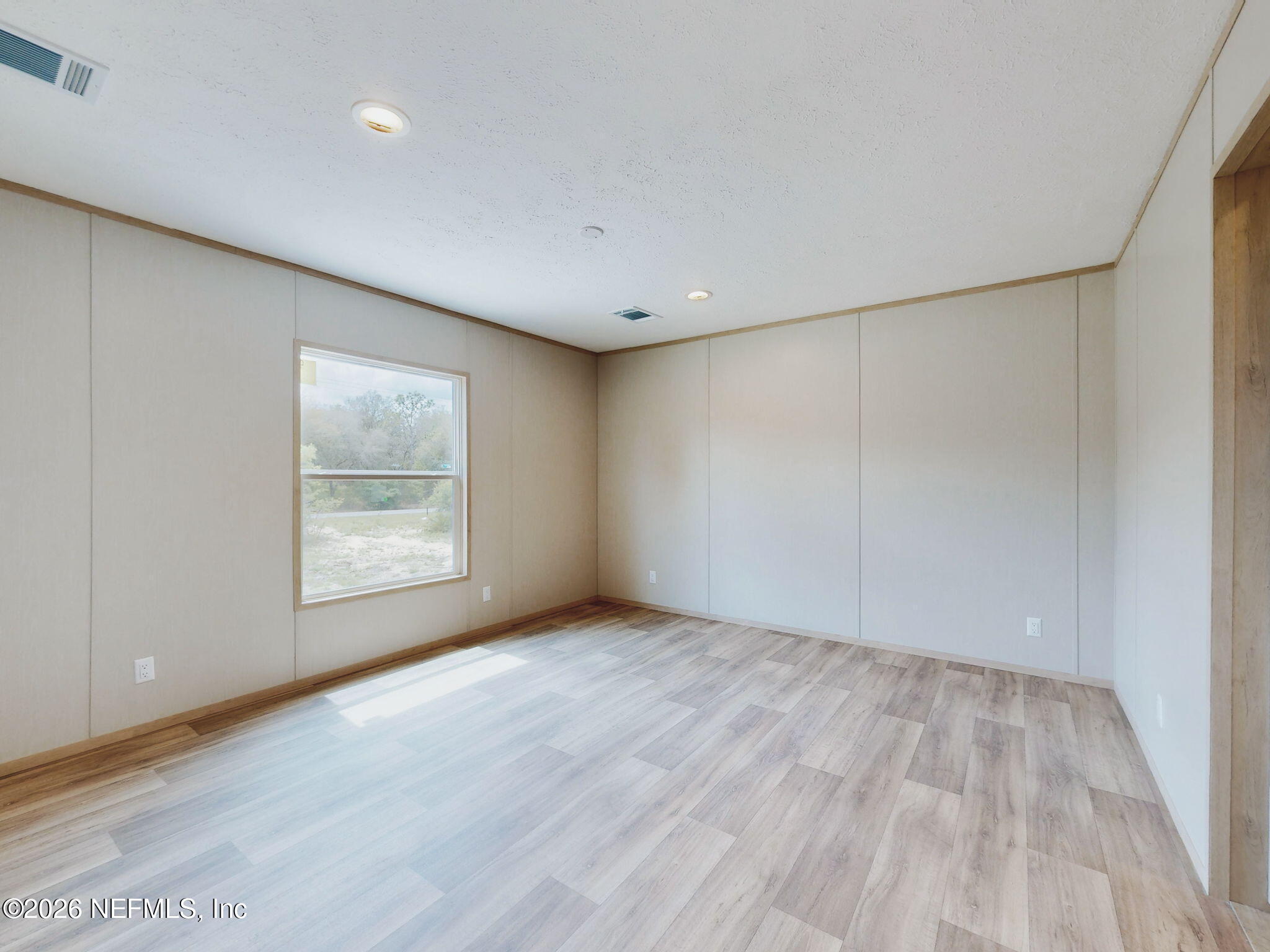 5784 County Road 214 Keystone Heights, FL 32656 - Photo 10 of 62 a view of an empty room with wooden floor and a window