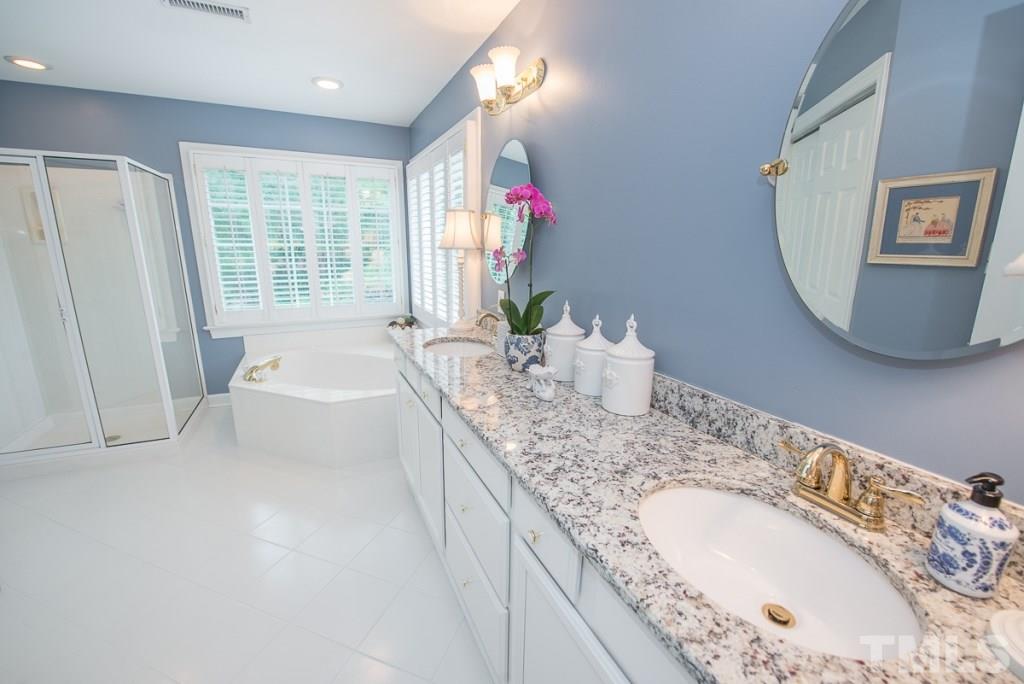 103 Springmoor Lane Durham, NC 27713 - Photo 12 of 25 The master bathroom has been updated with new cabinets with soft close doors and drawers, dual sink granite vanity, mirrors and fixtures, shutter and tile on the diagonal.