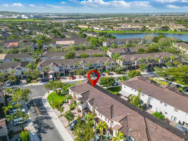 an aerial view of lake residential house with swimming pool
