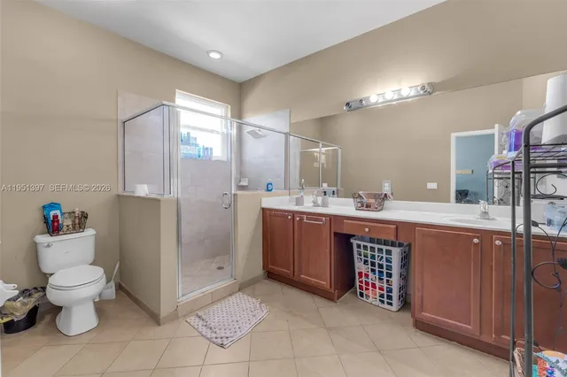 a bathroom with a sink vanity mirror and toilet