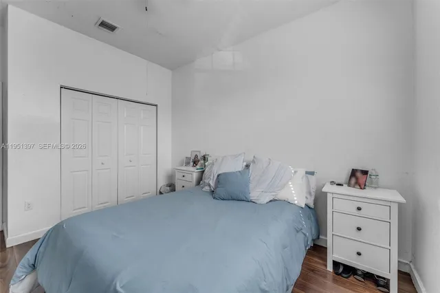 a bedroom with a bed and a dresser