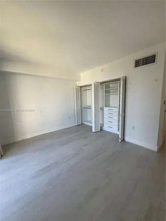 an empty room with an empty space and wooden floor