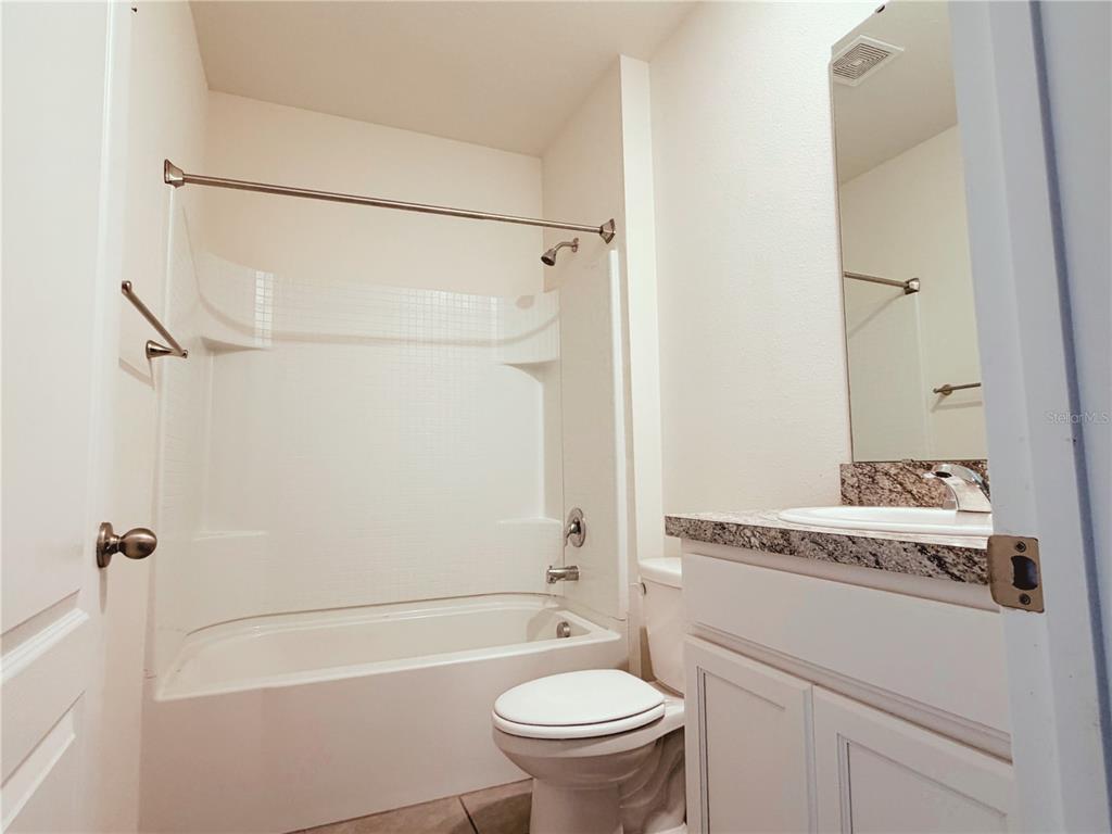 910 Sun Burst Road Winter Haven, FL 33880 - Photo 10 of 14 a bathroom with a granite countertop sink toilet and shower
