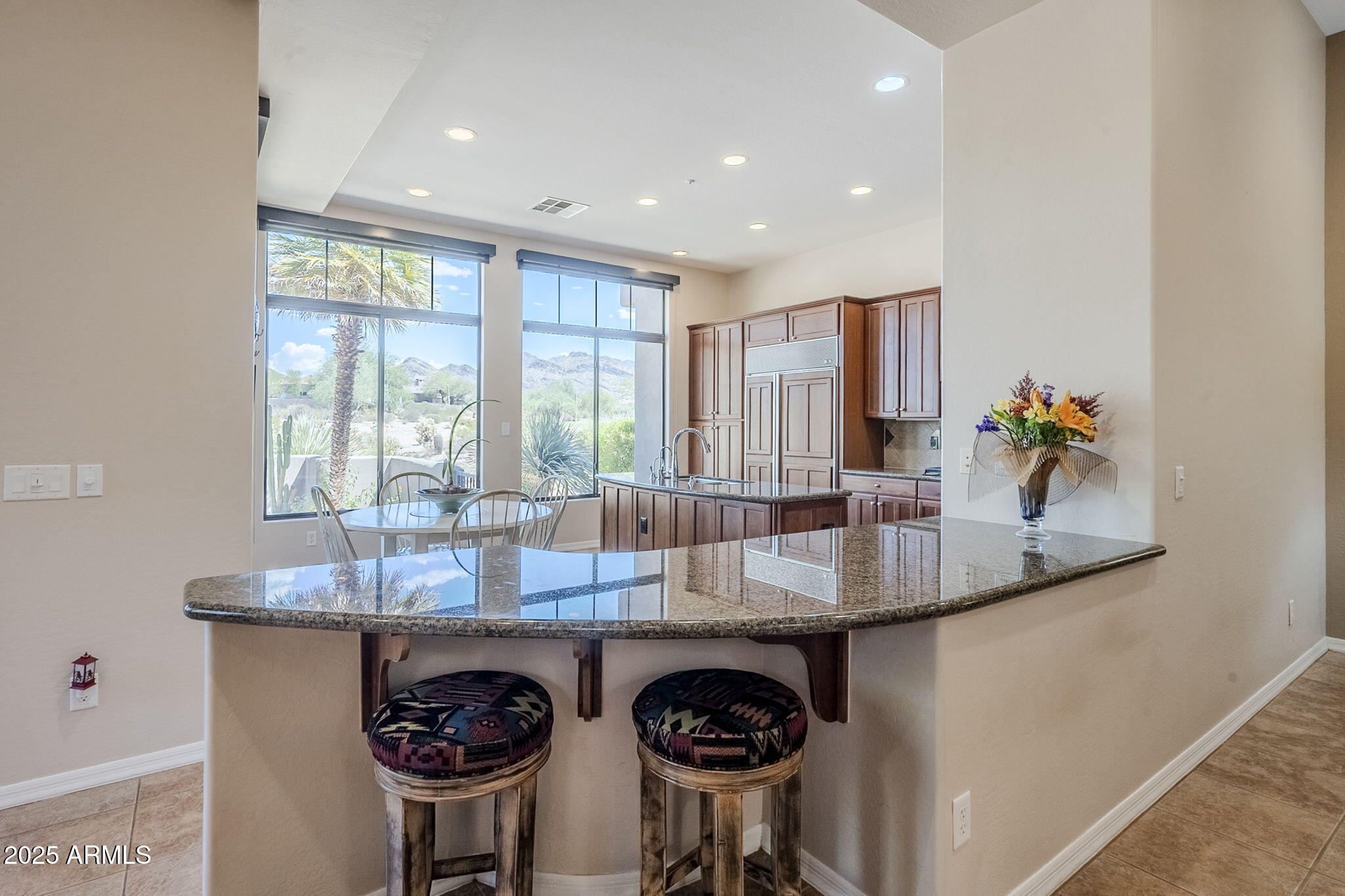 9270 East Thompson Peak Parkway, Unit 342 Scottsdale, AZ 85255 - Photo 12 of 40 a kitchen with stainless steel appliances granite countertop a sink a stove and a wooden floors