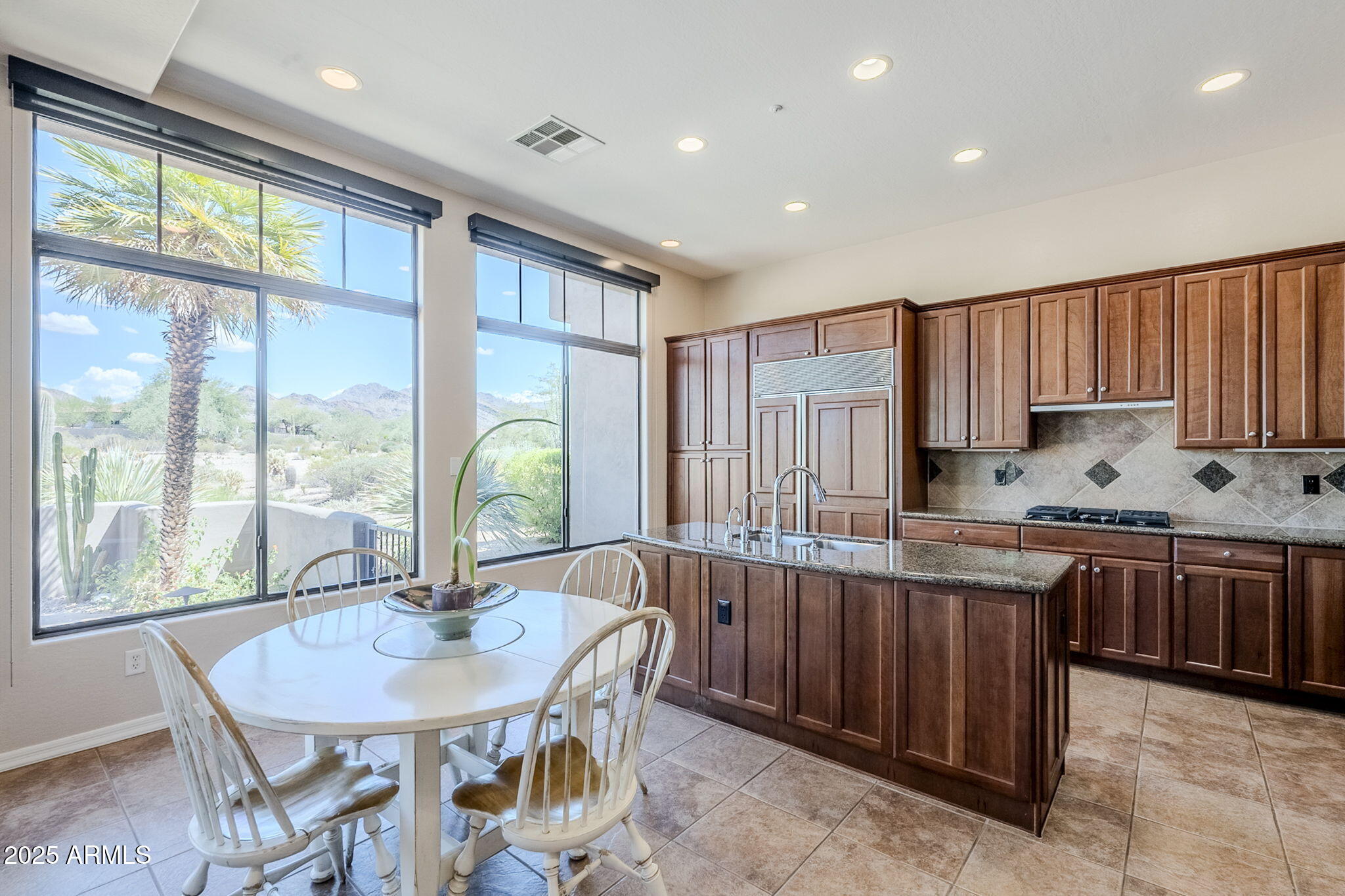 9270 East Thompson Peak Parkway, Unit 342 Scottsdale, AZ 85255 - Photo 13 of 40 a kitchen with stainless steel appliances granite countertop a stove a sink and a refrigerator