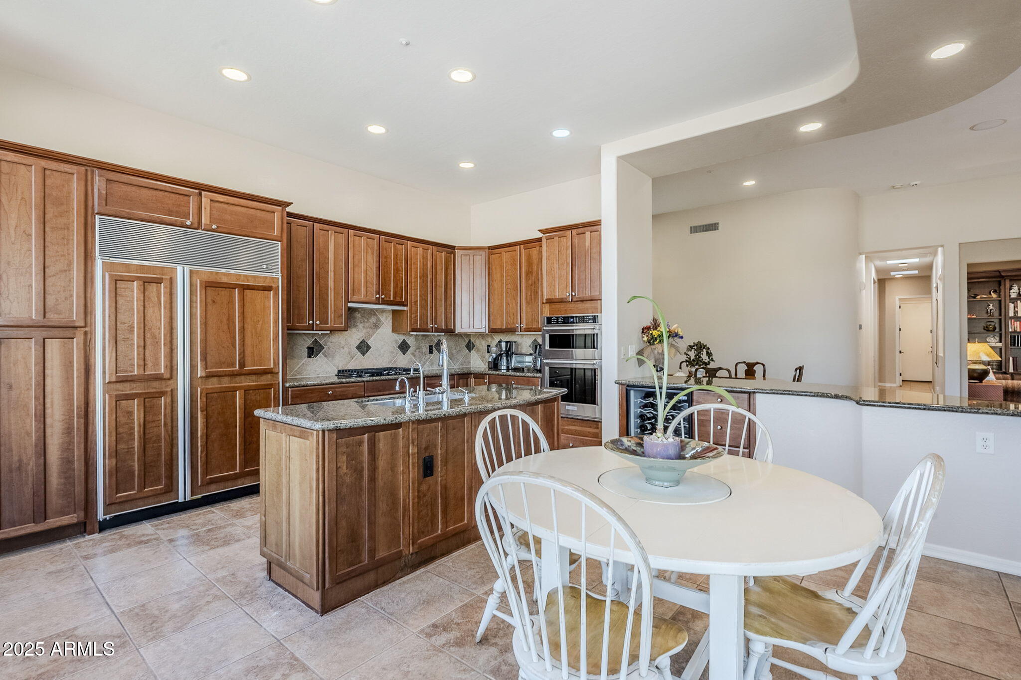 9270 East Thompson Peak Parkway, Unit 342 Scottsdale, AZ 85255 - Photo 14 of 40 a kitchen with stainless steel appliances kitchen island granite countertop a refrigerator and a stove top oven