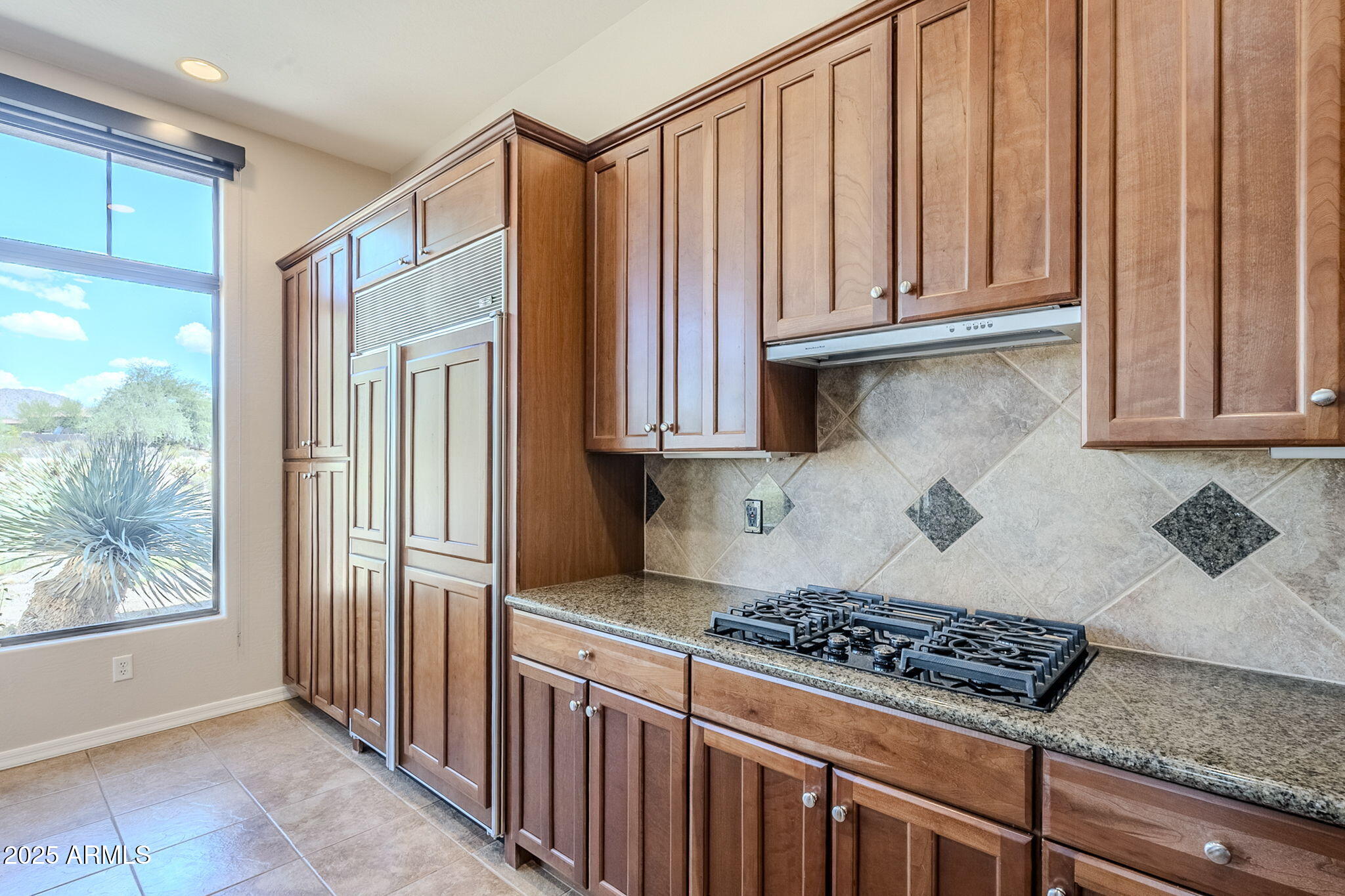 9270 East Thompson Peak Parkway, Unit 342 Scottsdale, AZ 85255 - Photo 17 of 40 a kitchen with wooden cabinets and a stove top oven