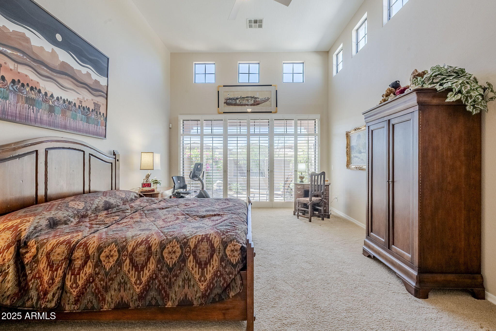9270 East Thompson Peak Parkway, Unit 342 Scottsdale, AZ 85255 - Photo 21 of 40 a bedroom with a bed mirror and a window