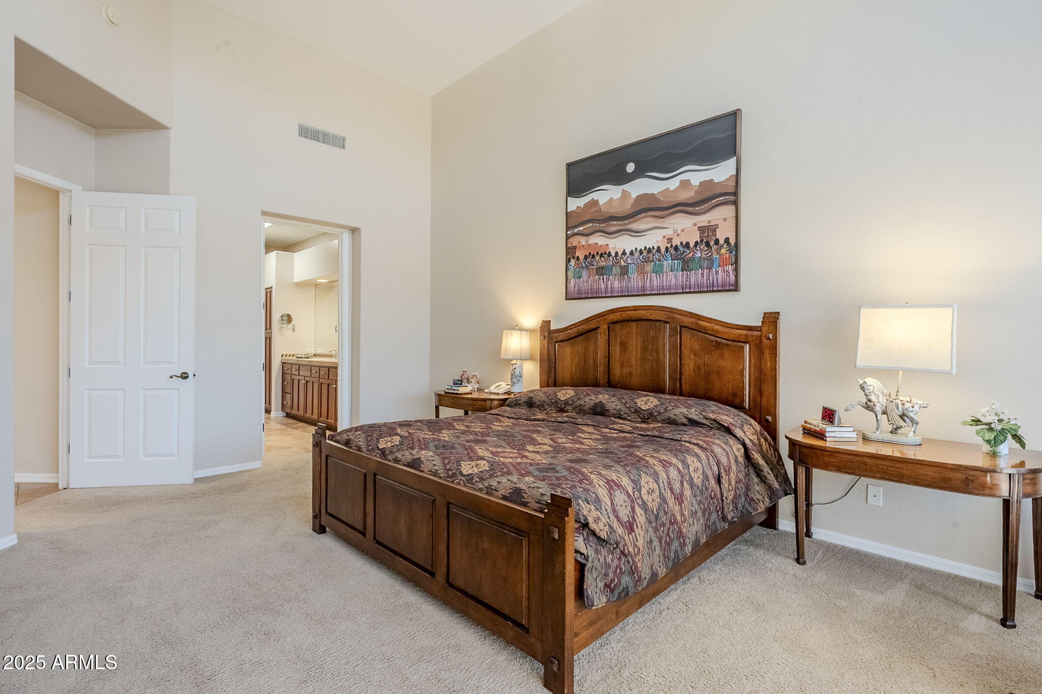 9270 East Thompson Peak Parkway, Unit 342 Scottsdale, AZ 85255 - Photo 22 of 40 a bedroom with a bed and a lamp on dresser