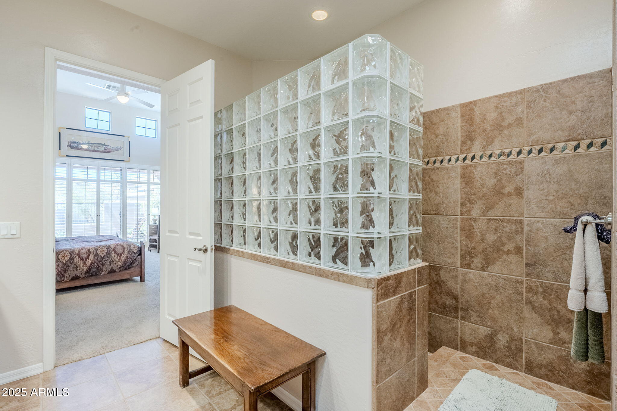 9270 East Thompson Peak Parkway, Unit 342 Scottsdale, AZ 85255 - Photo 25 of 40 a view of a bedroom with a bed and wooden floor