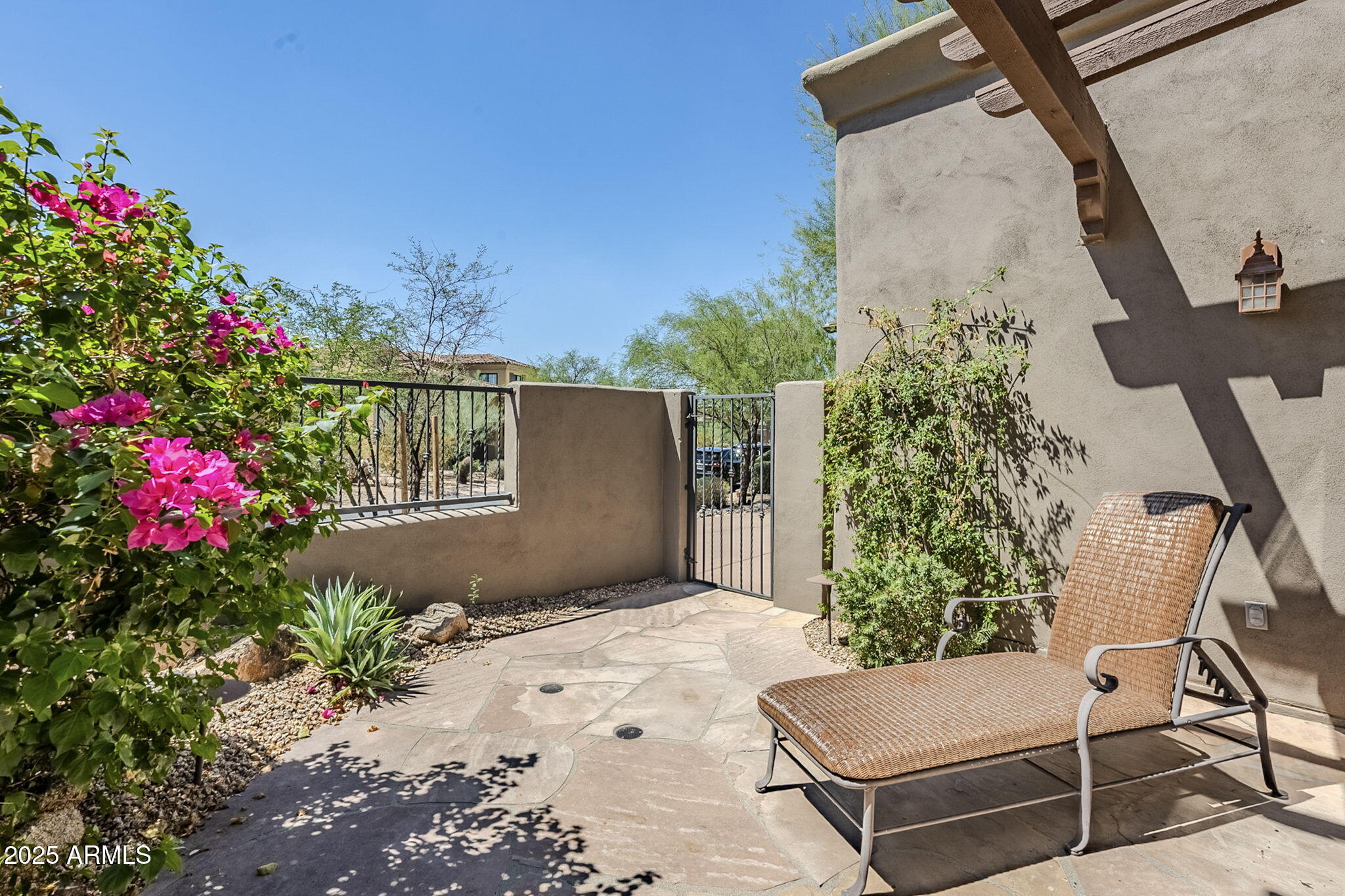 9270 East Thompson Peak Parkway, Unit 342 Scottsdale, AZ 85255 - Photo 29 of 40 a view of backyard with potted plants and a bench