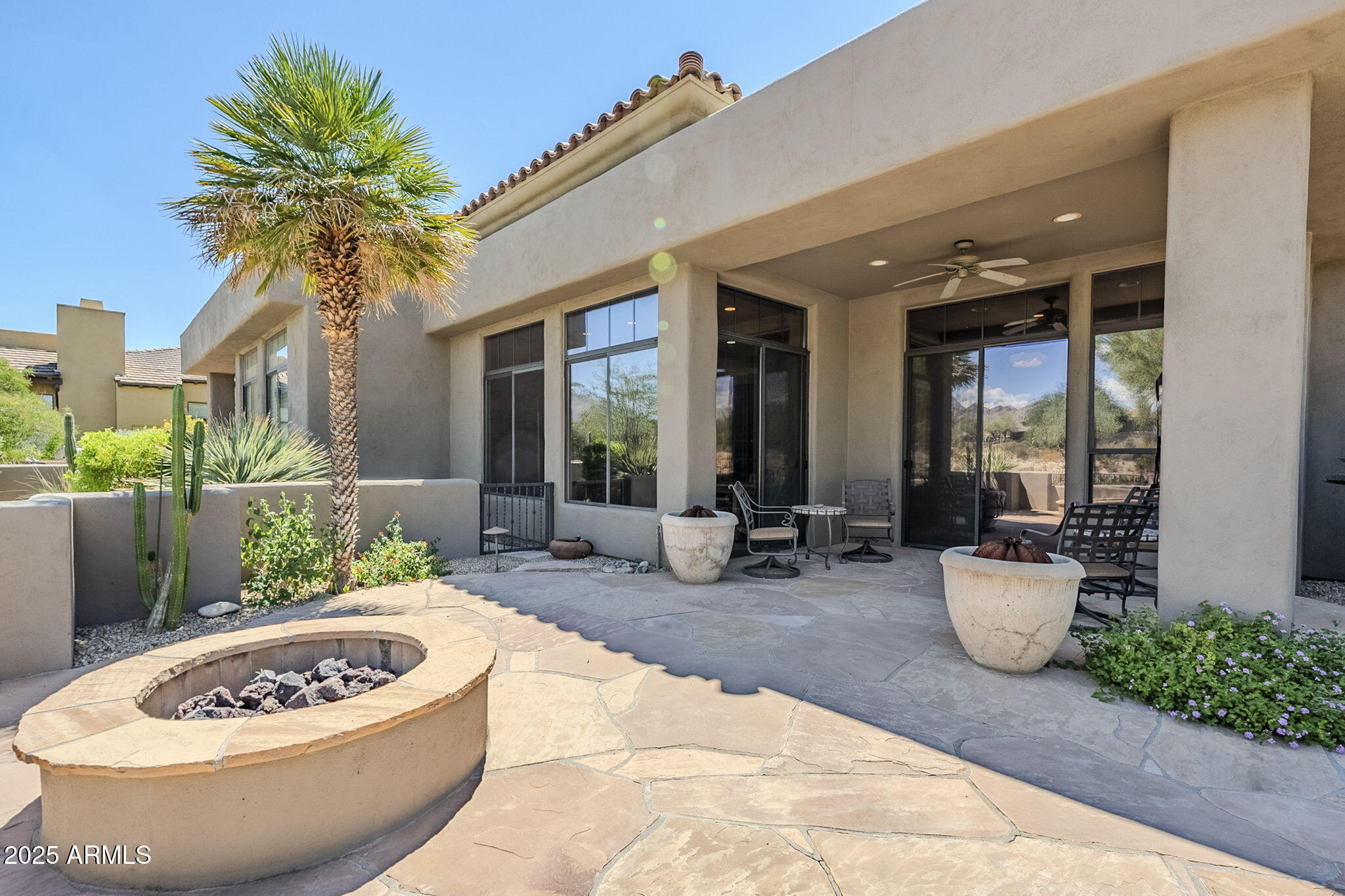 9270 East Thompson Peak Parkway, Unit 342 Scottsdale, AZ 85255 - Photo 37 of 40 a view of a chairs and fire pit in the patio
