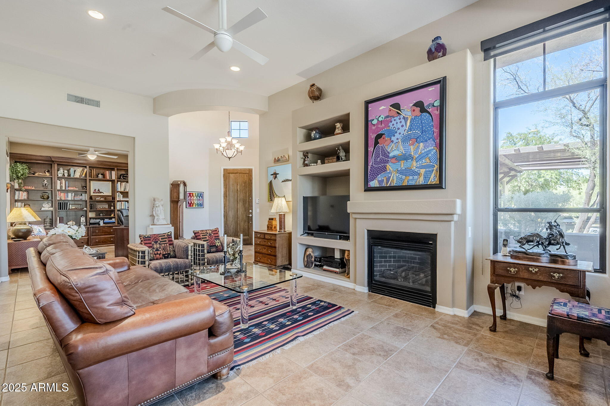 9270 East Thompson Peak Parkway, Unit 342 Scottsdale, AZ 85255 - Photo 6 of 40 a living room with furniture a fireplace and windows