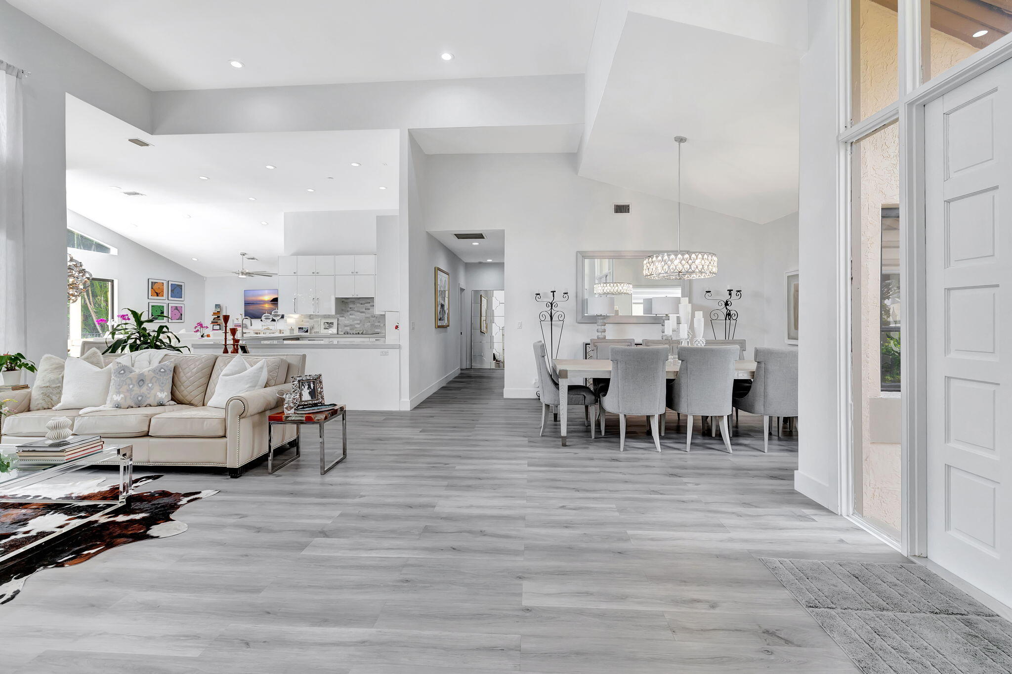 2298 Northwest 57th Street Boca Raton, FL 33496 - Photo 8 of 111 a living room with furniture and a dining table with kitchen view
