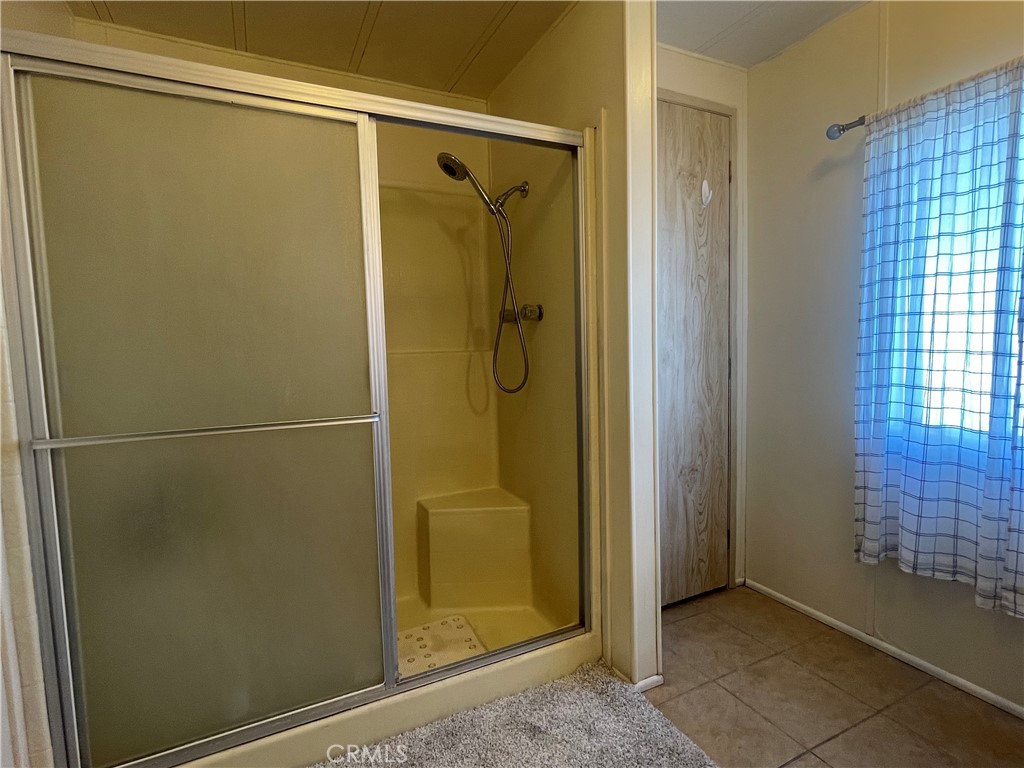 74711 Dillon Road, Unit 411 Desert Hot Springs, CA 92241 - Photo 11 of 26 a bathroom with a glass shower door