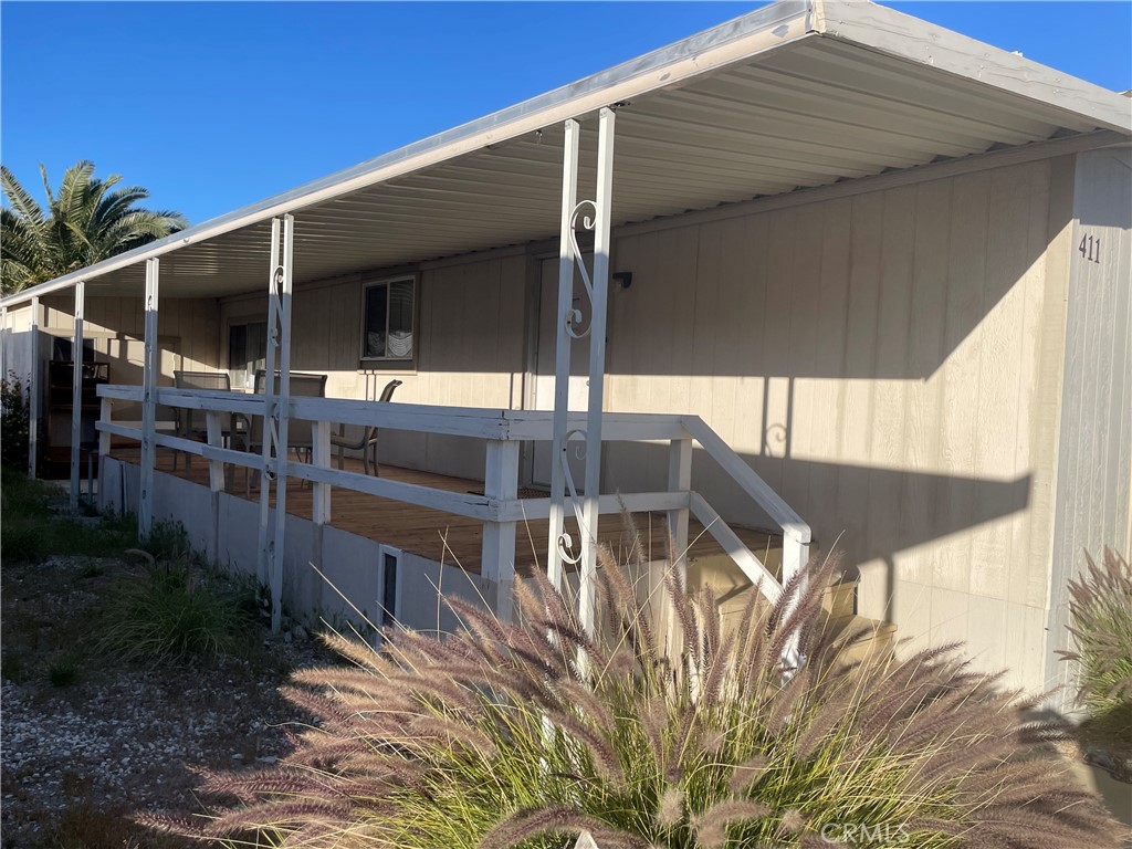 74711 Dillon Road, Unit 411 Desert Hot Springs, CA 92241 - Photo 15 of 26 a view of house with outdoor space and seating area