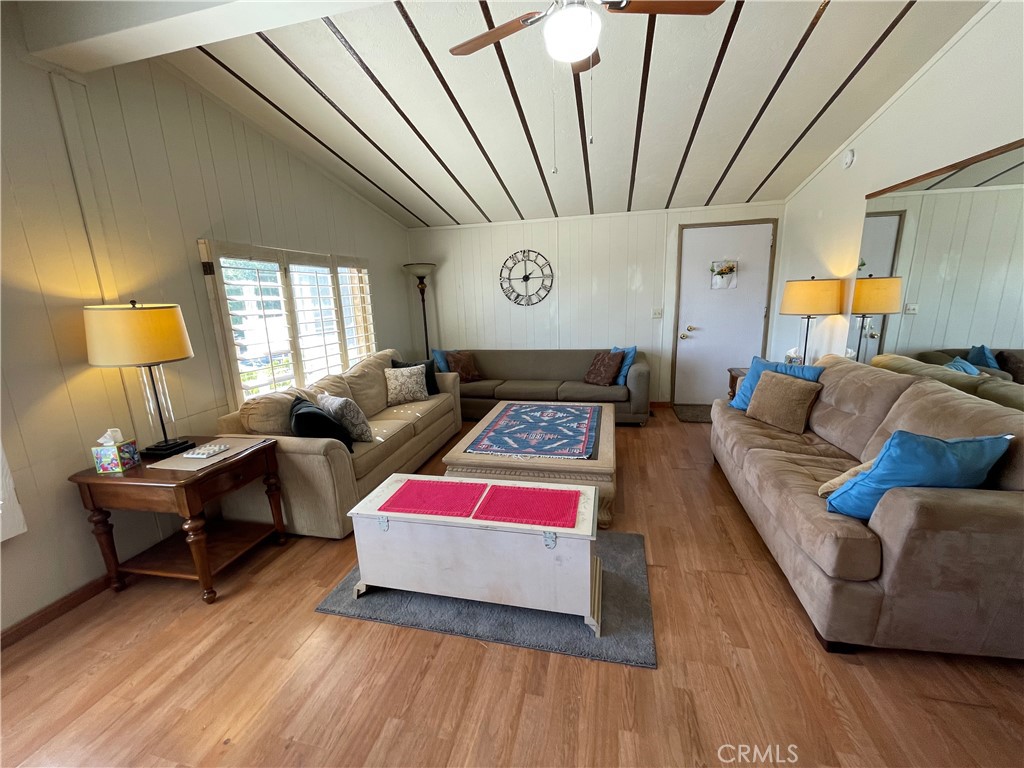 74711 Dillon Road, Unit 411 Desert Hot Springs, CA 92241 - Photo 2 of 26 a living room with furniture and a wooden floor