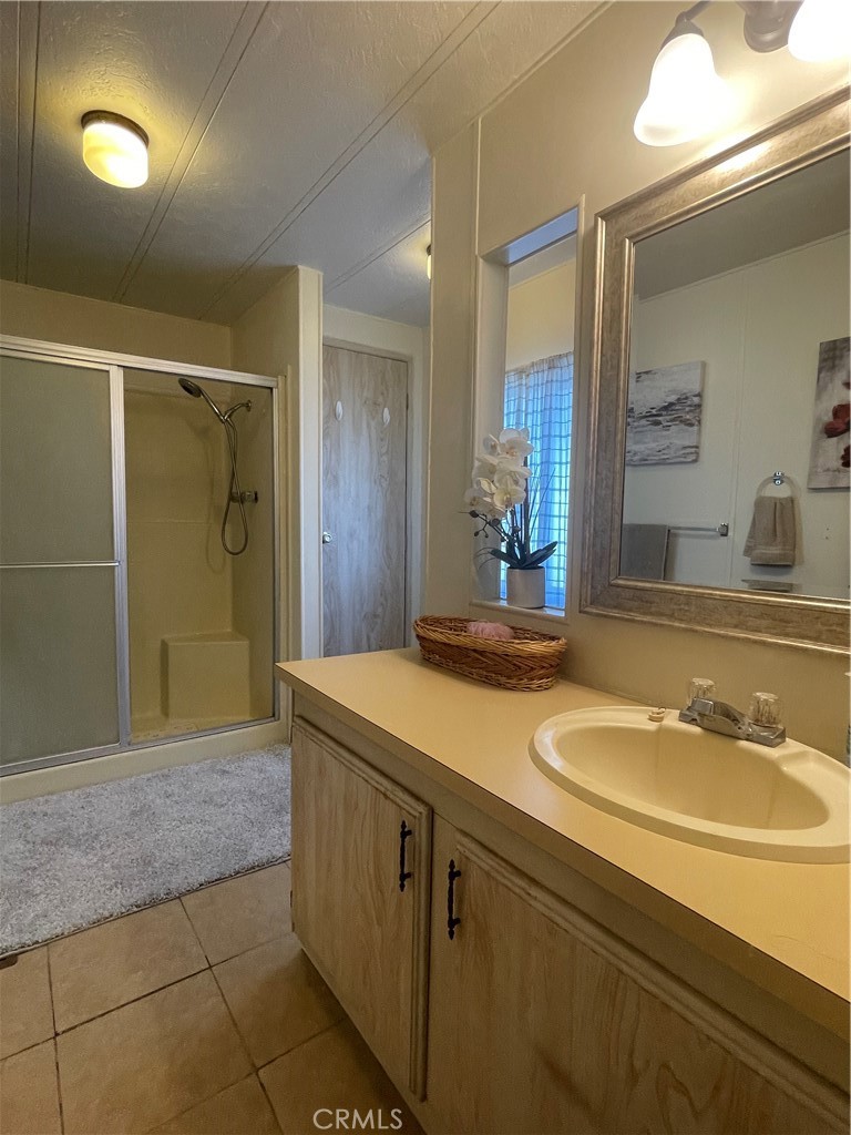 74711 Dillon Road, Unit 411 Desert Hot Springs, CA 92241 - Photo 10 of 26 a bathroom with a sink and a mirror