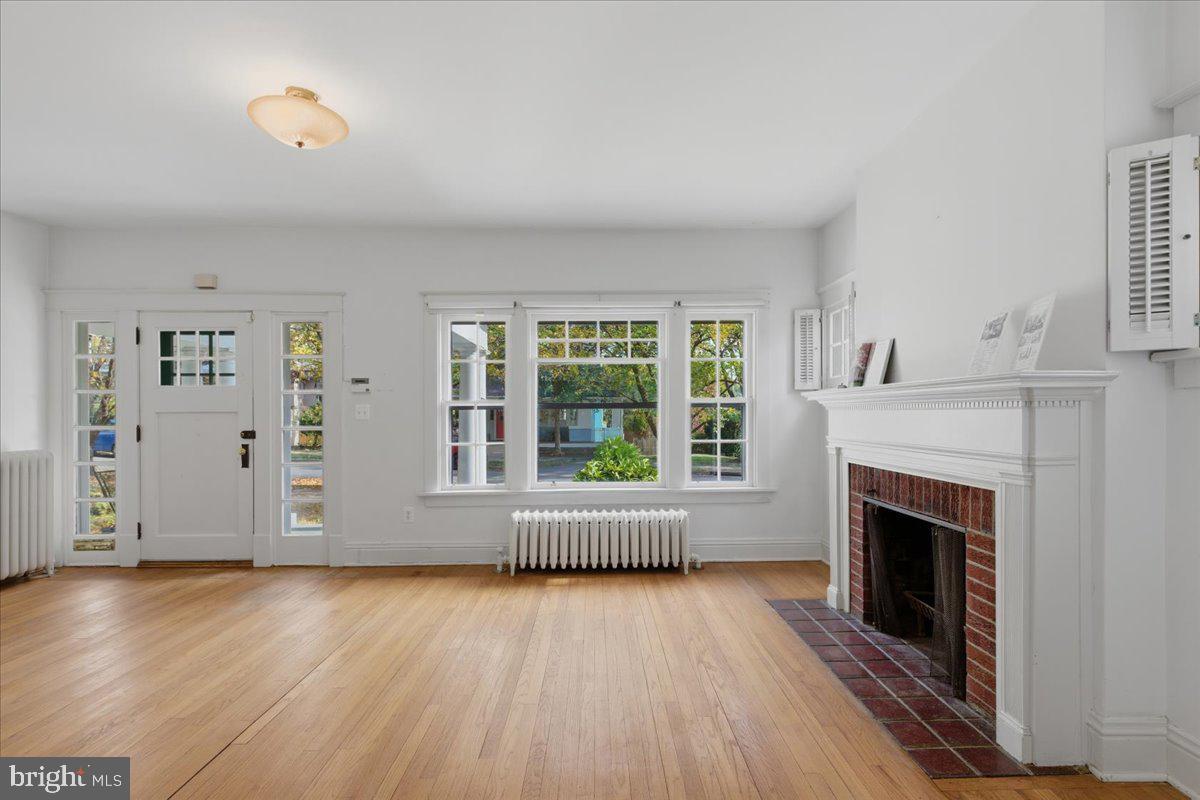 5900 32nd Street Northwest Washington, DC 20015 - Photo 11 of 51 wooden floor fireplace and windows in an empty room