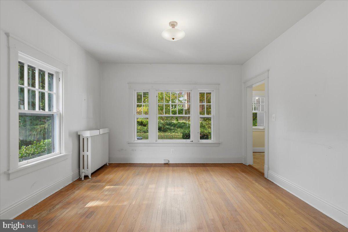 5900 32nd Street Northwest Washington, DC 20015 - Photo 12 of 51 an empty room with wooden floor and windows