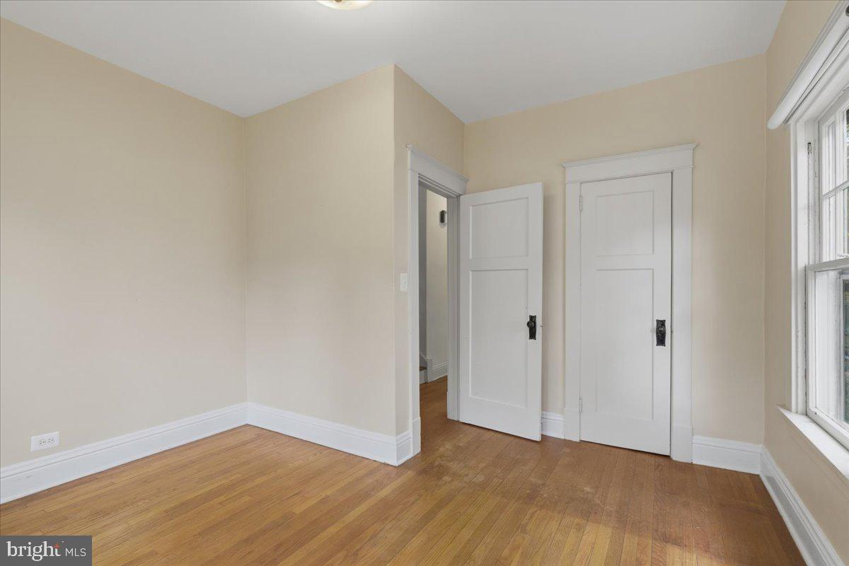 5900 32nd Street Northwest Washington, DC 20015 - Photo 23 of 51 a view of an empty room with wooden floor and a window