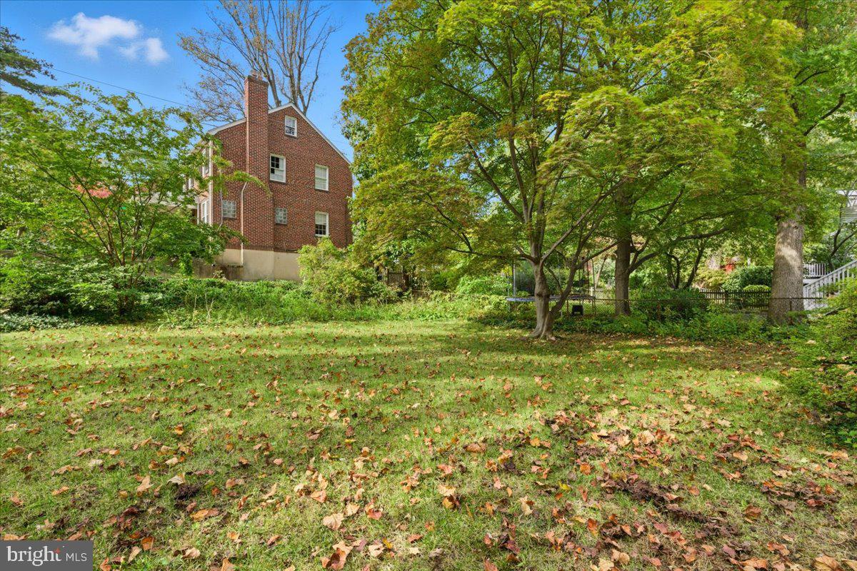 5900 32nd Street Northwest Washington, DC 20015 - Photo 46 of 51 a yellow building in the middle of a yard