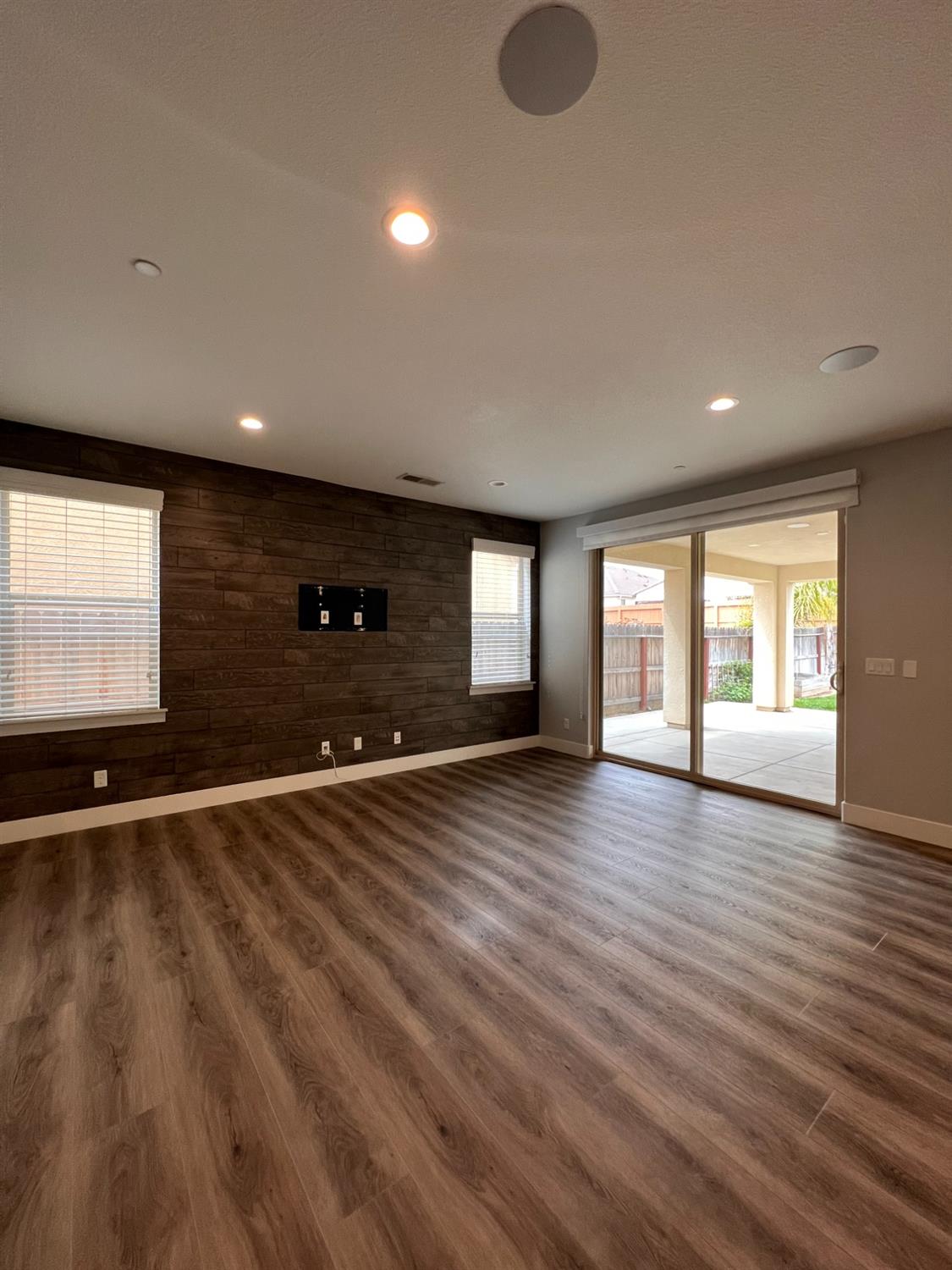 445 Expedition Avenue Madera, CA 93636 - Photo 12 of 36 a view of an empty room with wooden floor and a window