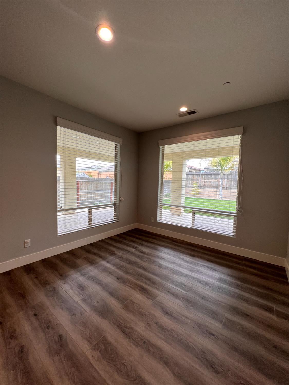 445 Expedition Avenue Madera, CA 93636 - Photo 14 of 36 a view of an empty room with wooden floor and a window