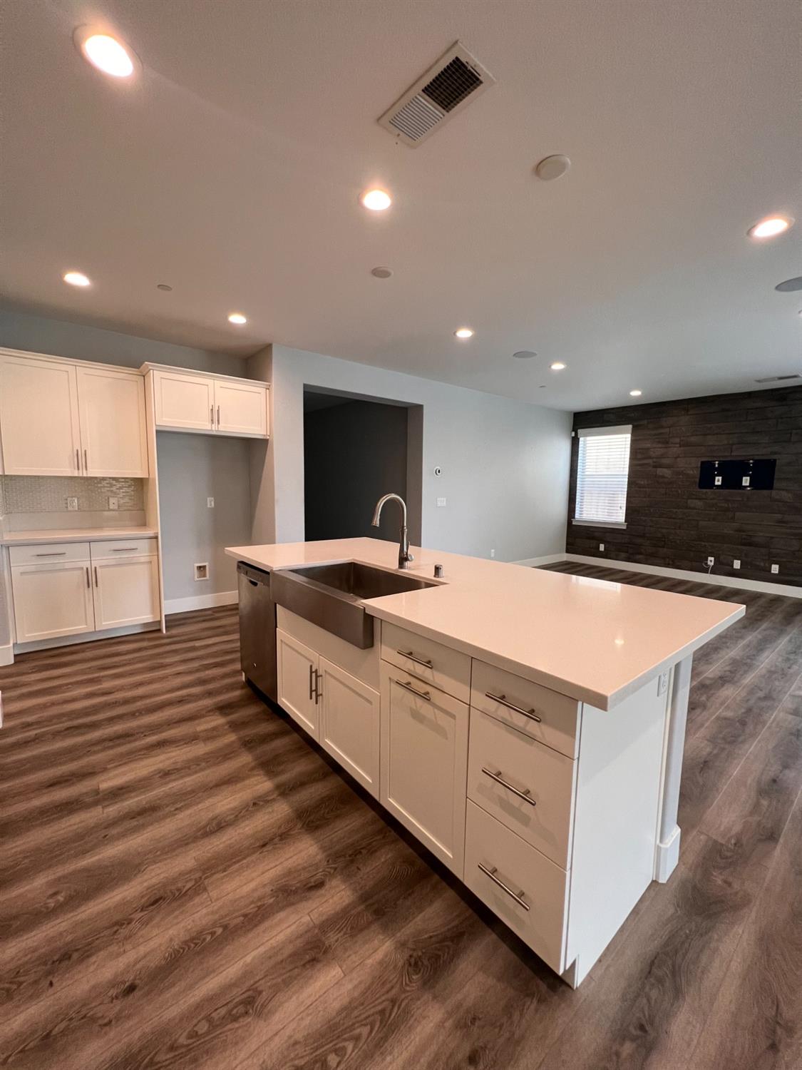445 Expedition Avenue Madera, CA 93636 - Photo 17 of 36 a large kitchen with stainless steel appliances a large counter top a stove and a refrigerator