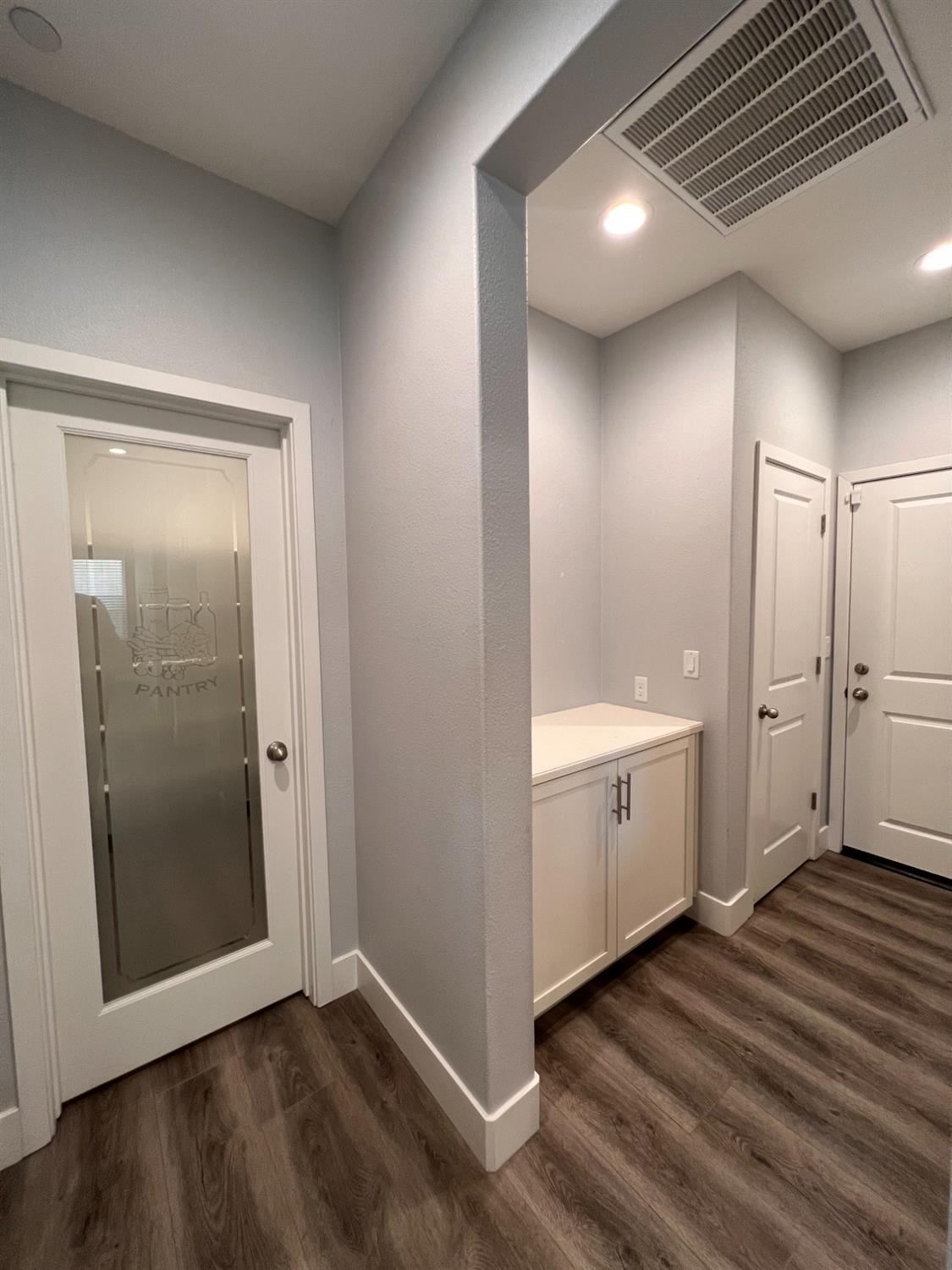 445 Expedition Avenue Madera, CA 93636 - Photo 18 of 36 a view of a hallway with closet and wooden floor