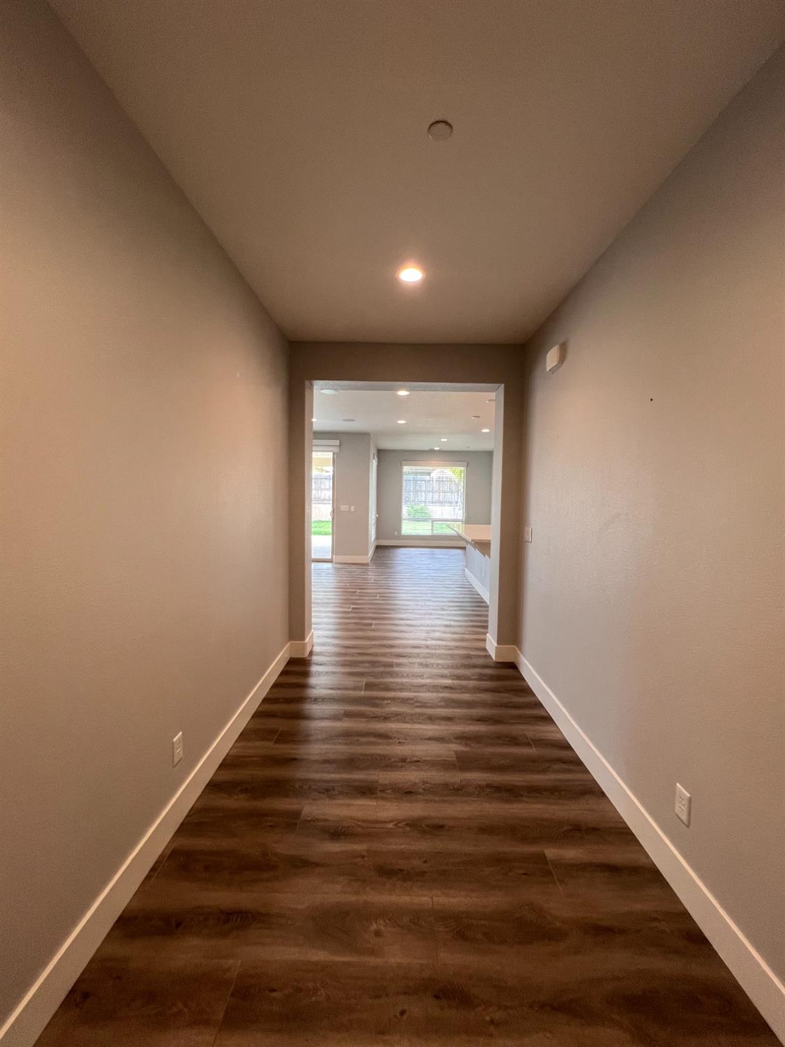 445 Expedition Avenue Madera, CA 93636 - Photo 2 of 36 a view of wooden floor and windows in a room