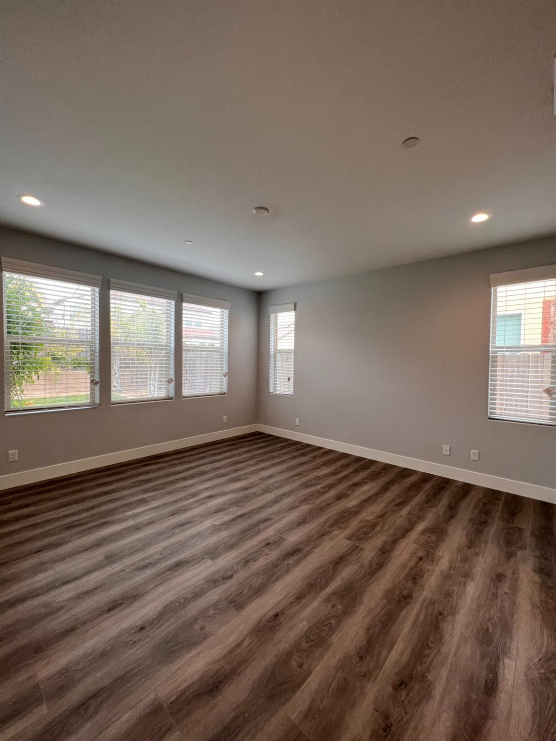 445 Expedition Avenue Madera, CA 93636 - Photo 24 of 36 a view of an empty room with wooden floor and a window