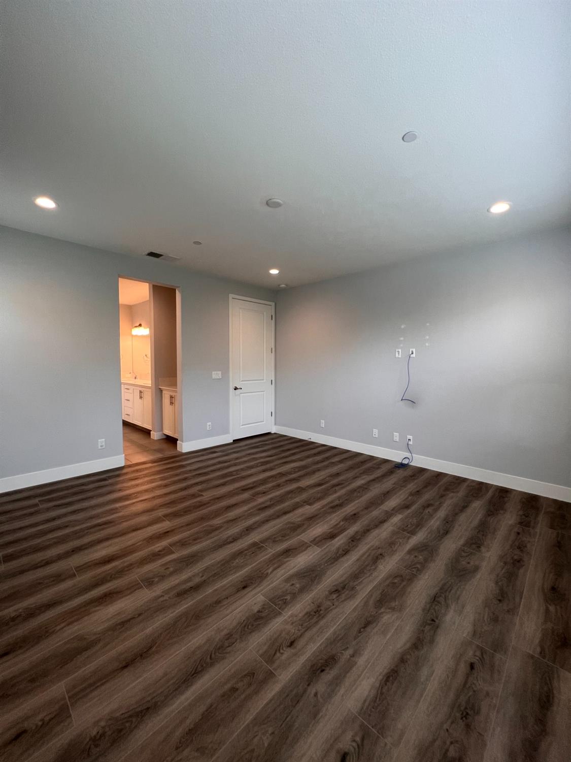 445 Expedition Avenue Madera, CA 93636 - Photo 25 of 36 an empty room with wooden floor and window