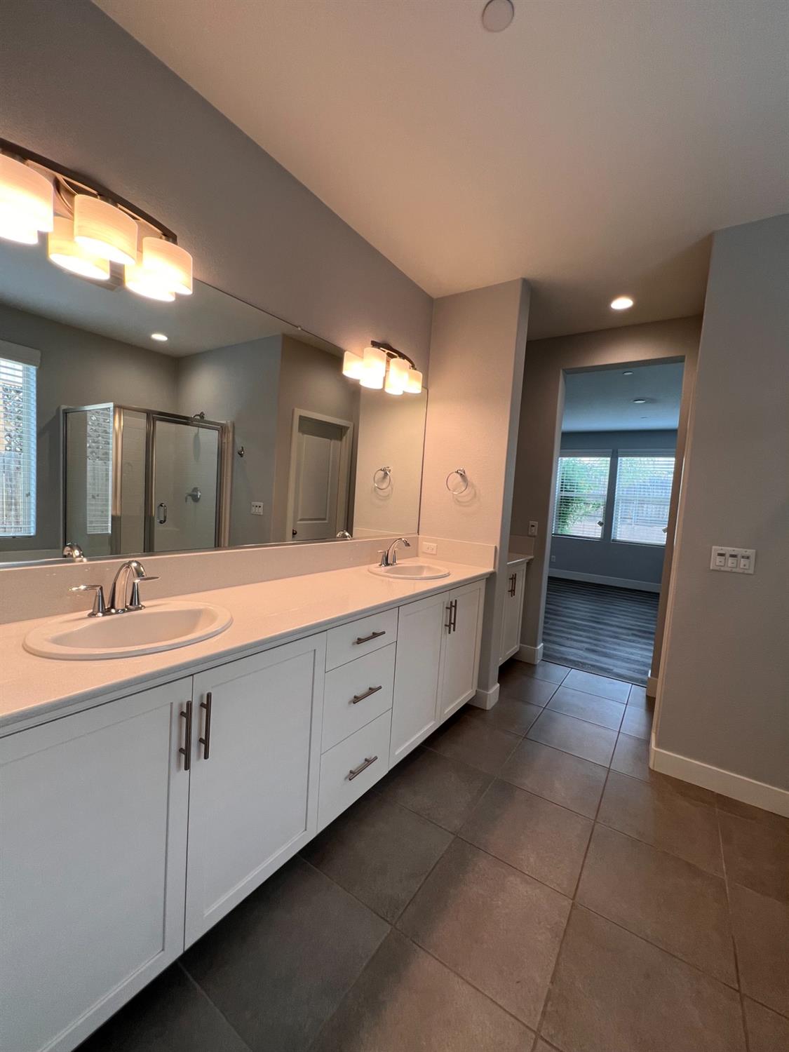 445 Expedition Avenue Madera, CA 93636 - Photo 28 of 36 a spacious bathroom with a double vanity sink and a mirror
