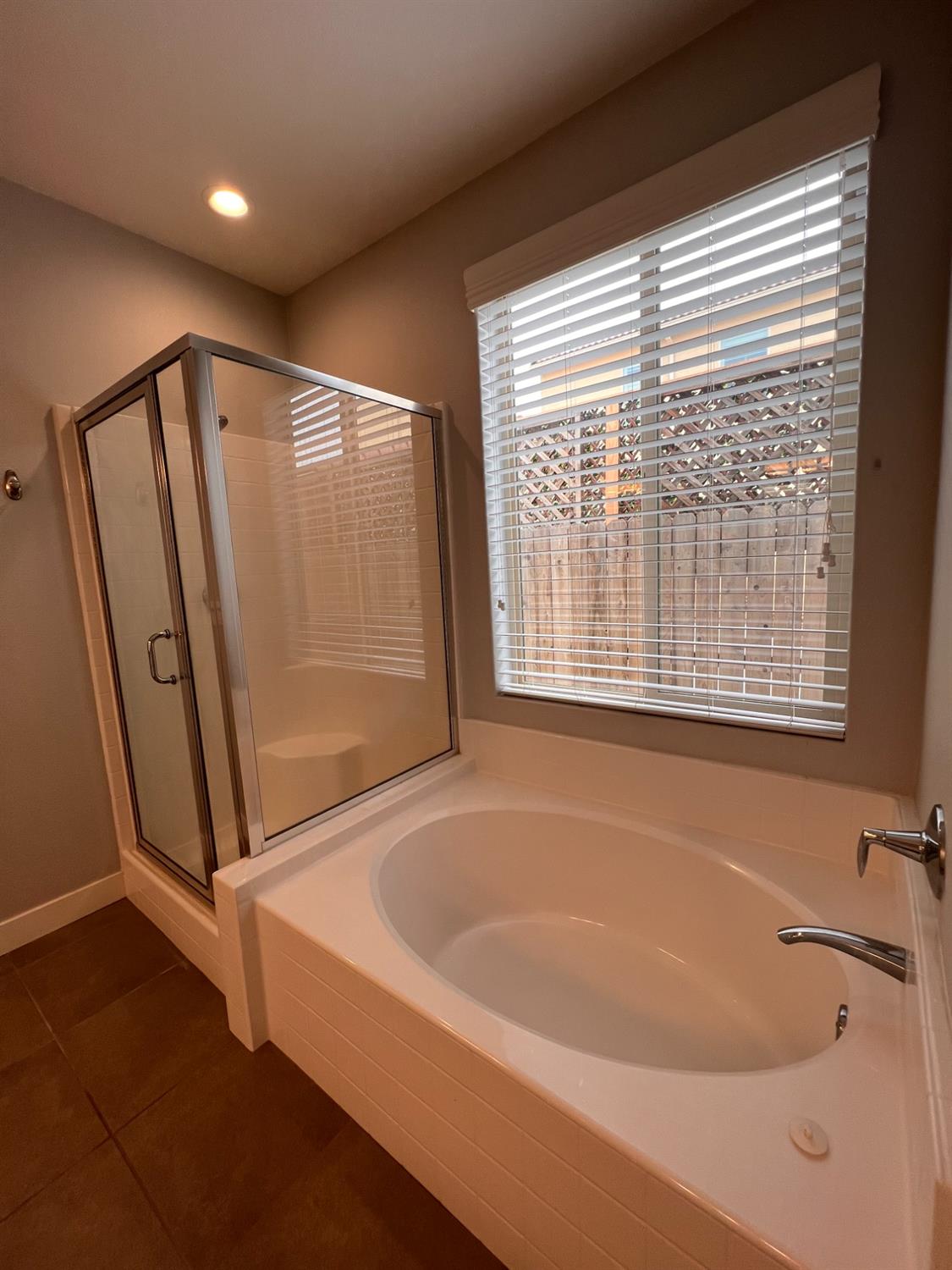 445 Expedition Avenue Madera, CA 93636 - Photo 29 of 36 a bathroom with bathtub and a shower