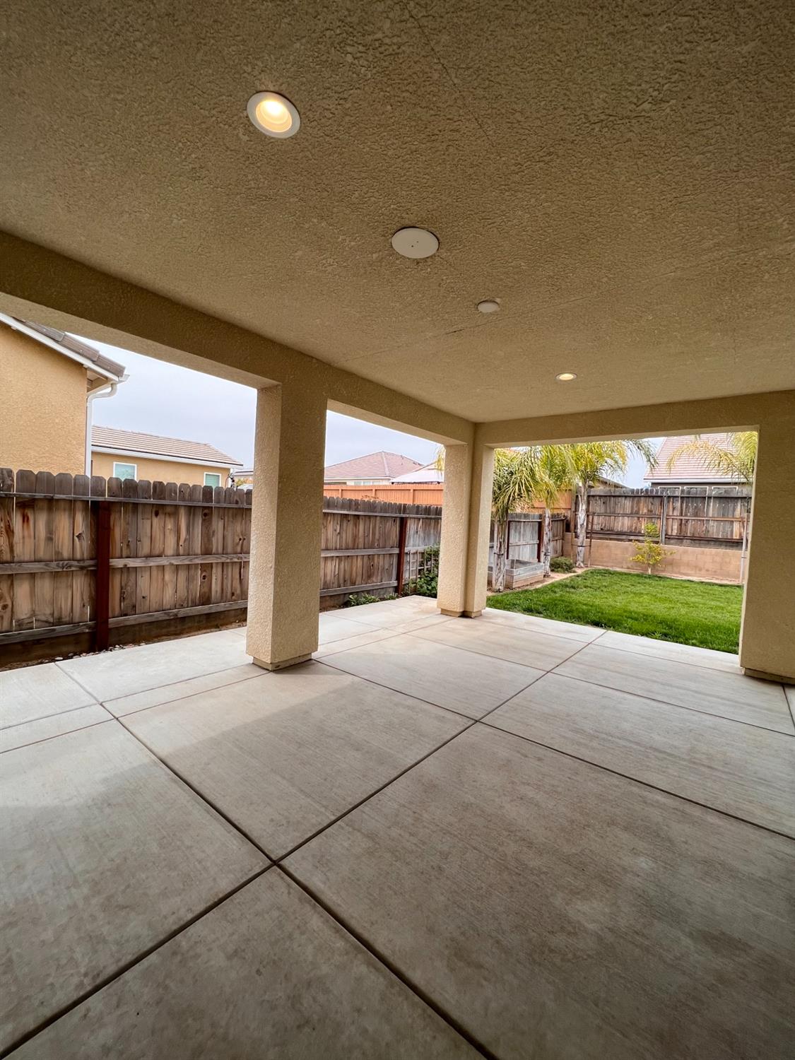 445 Expedition Avenue Madera, CA 93636 - Photo 33 of 36 a view of an empty room with a fireplace and a garden