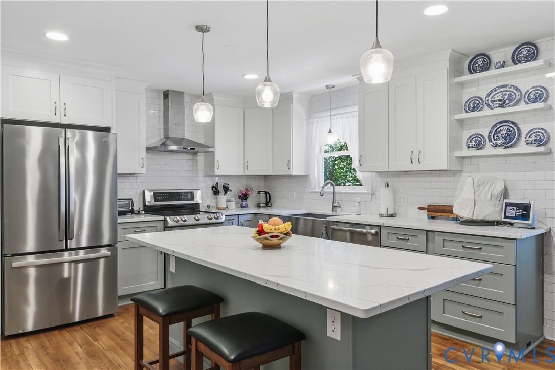 12512 2nd Branch Road Chesterfield, VA 23838 - Photo 14 of 56 a kitchen with stainless steel appliances a sink a stove a refrigerator and white cabinets with wooden floor