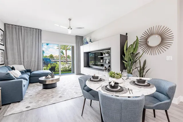 a dining room with furniture window and outdoor view