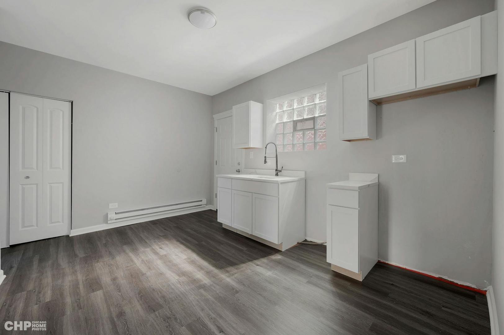 16 East 118th Place, Unit 1F Chicago, IL 60628 - Photo 2 of 10 a view of a room with wooden floor and sink