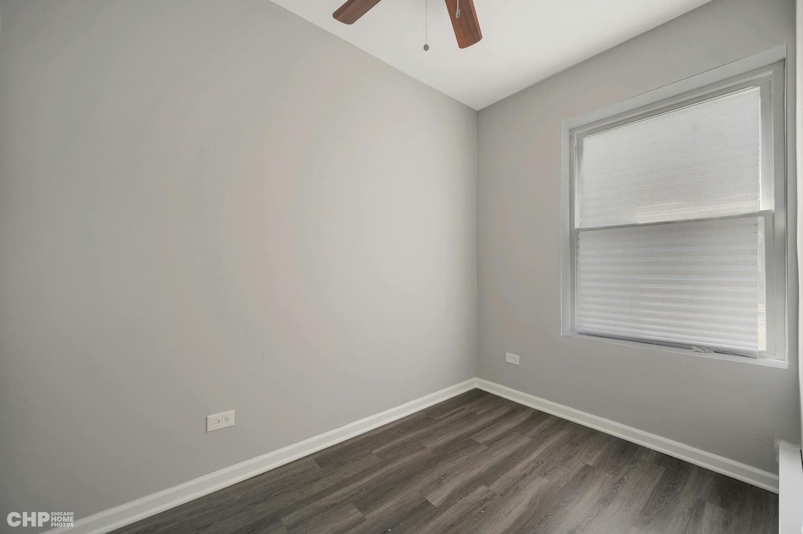 16 East 118th Place, Unit 1F Chicago, IL 60628 - Photo 8 of 10 an empty room with a window