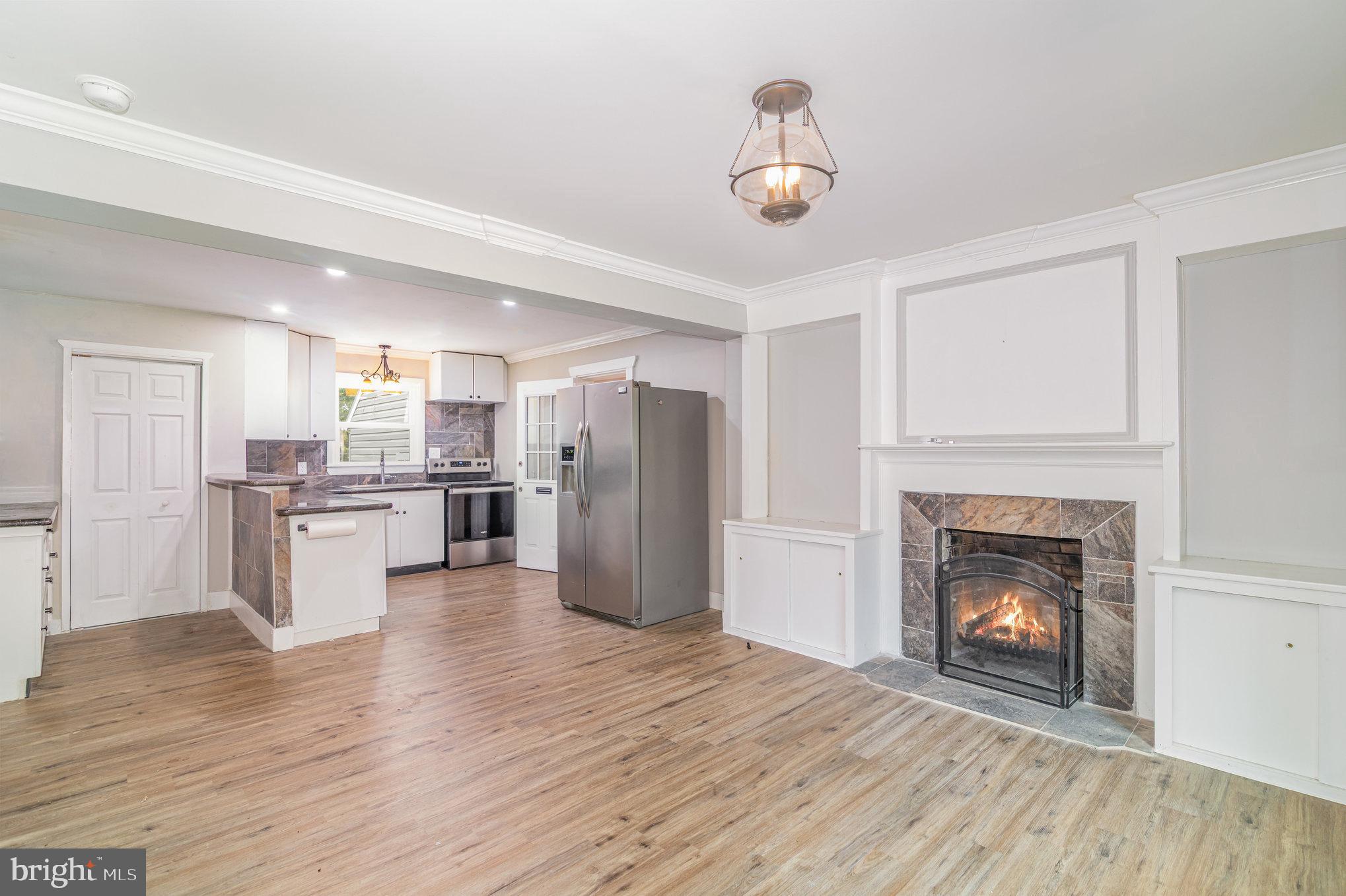 191 Pinetown Road Leola, PA 17540 - Photo 6 of 34 a view of kitchen with a refrigerator a fireplace and wooden floor