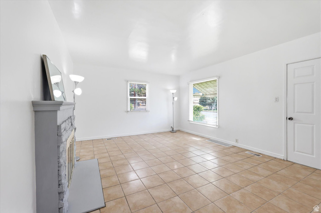 676 South 500 West Provo, UT 84601 - Photo 6 of 29 Unfurnished living room featuring light tile patterned floors and a fireplace