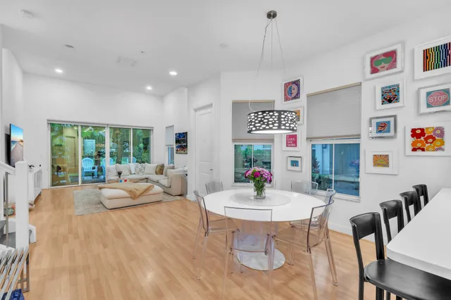 a view of hallway with furniture and wooden floor