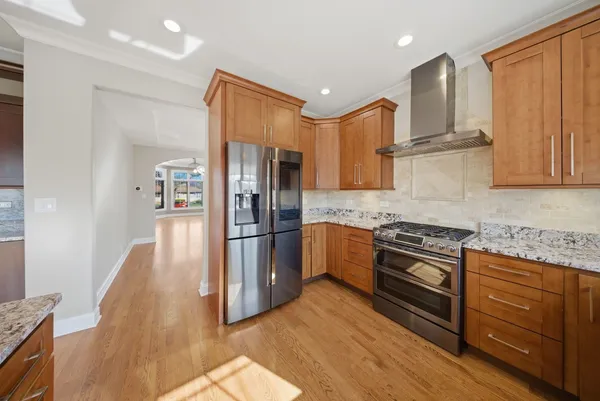 a kitchen with granite countertop stainless steel appliances and wooden cabinets