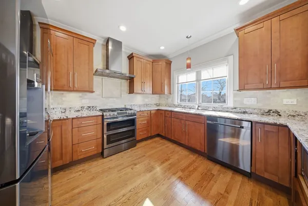 a kitchen with stainless steel appliances granite countertop a stove a sink dishwasher and a refrigerator