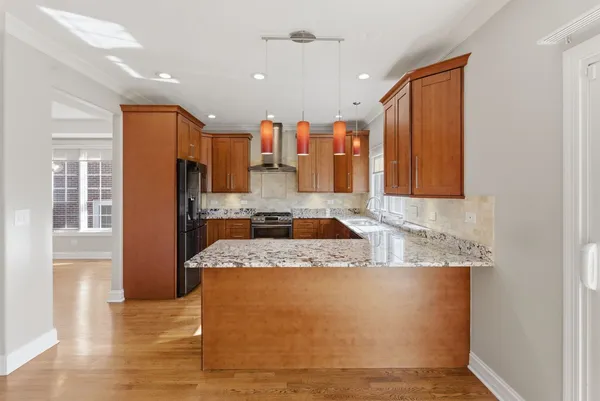 a large kitchen with stainless steel appliances granite countertop a granite counter tops and a refrigerator
