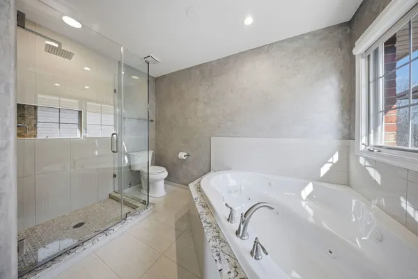 a bathroom with a bathtub and a shower