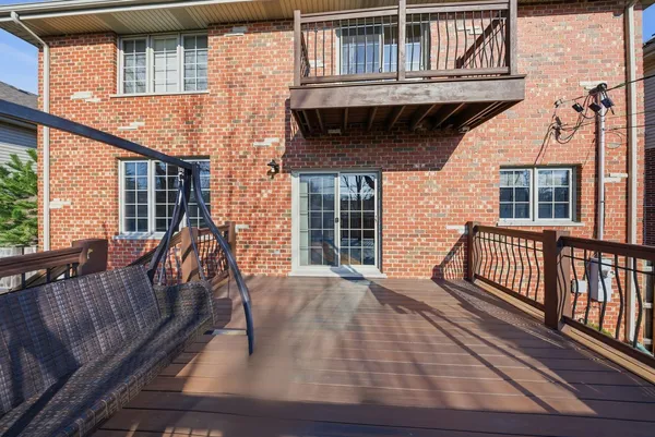 a view of a house with wooden deck