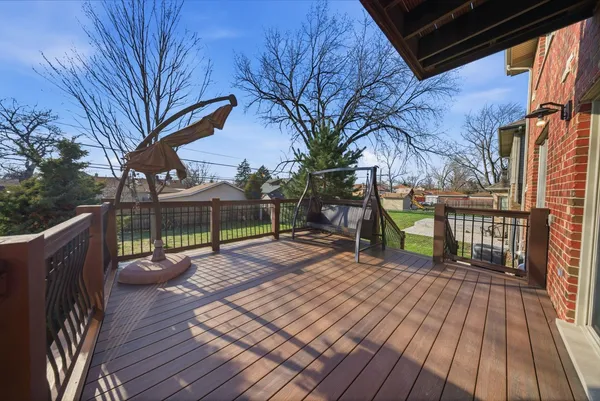 a view of a deck with wooden floor and fence