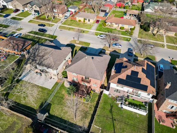 an aerial view of a houses with yard